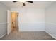 Spacious bedroom features neutral carpet, light-grey walls, and a doorway to hallway at 6322 Old Pineville Rd # E, Charlotte, NC 28217