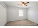 Bedroom features a ceiling fan and window for natural light at 6322 Old Pineville Rd # E, Charlotte, NC 28217
