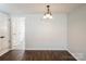 The dining room features sleek hardwood floors and a modern lighting fixture at 6322 Old Pineville Rd # E, Charlotte, NC 28217