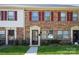 Charming brick townhome featuring colorful shutters and well-manicured lawn at 6322 Old Pineville Rd # E, Charlotte, NC 28217