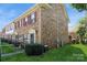 Brick townhome featuring well-maintained landscaping, a covered porch and multiple stories at 6322 Old Pineville Rd # E, Charlotte, NC 28217