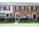 Inviting exterior view of brick townhomes featuring red shutters, well-manicured lawns, and visible unit numbers at 6322 Old Pineville Rd # E, Charlotte, NC 28217
