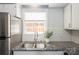Bright kitchen showcasing granite countertops, white subway tile backsplash, and stainless steel sink at 6322 Old Pineville Rd # E, Charlotte, NC 28217