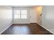 Cozy living room with hardwood floors and a view of the front entrance and staircase at 6322 Old Pineville Rd # E, Charlotte, NC 28217