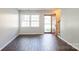 Inviting living room with hardwood floors, large window, and view of the front door and staircase at 6322 Old Pineville Rd # E, Charlotte, NC 28217