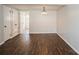 Open living room showcasing hardwood floors, fresh paint, and hallway access at 6322 Old Pineville Rd # E, Charlotte, NC 28217