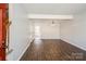Bright living room showcasing hardwood floors, fresh paint, and staircase access at 6322 Old Pineville Rd # E, Charlotte, NC 28217
