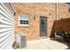 Cozy patio with brick wall, outdoor seating, and rear entrance at 6322 Old Pineville Rd # E, Charlotte, NC 28217