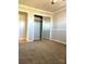 Bedroom with carpet flooring, paneled walls, and a mirrored closet at 742 Aquadale Rd, Albemarle, NC 28001