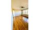 Bedroom with wood-look floors, a ceiling fan, and paneled walls at 742 Aquadale Rd, Albemarle, NC 28001