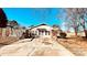 Cozy white cottage with brick accents, a covered entrance, and a cracked driveway at 742 Aquadale Rd, Albemarle, NC 28001