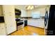Bright kitchen featuring stainless steel appliances and tiled backsplash at 742 Aquadale Rd, Albemarle, NC 28001