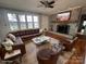 Bright living room with a decorative fireplace, and a large sofa next to expansive windows at 742 Aquadale Rd, Albemarle, NC 28001