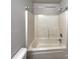Clean bathroom with a tub and shower combination, featuring a curved shower rod at 8353 Ainsworth St, Charlotte, NC 28216