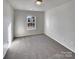 Carpeted bedroom with a window and neutral walls, ideal for a peaceful retreat at 8353 Ainsworth St, Charlotte, NC 28216