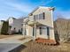 Two-story home with green front door, black shutters, and driveway at 8353 Ainsworth St, Charlotte, NC 28216