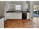 Functional kitchen featuring white cabinets, dark countertops, and essential appliances at 8353 Ainsworth St, Charlotte, NC 28216