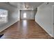 Bright living room with wood-look flooring, ceiling fan, and multiple windows providing natural light at 8353 Ainsworth St, Charlotte, NC 28216