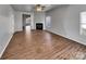 Spacious open-concept living room featuring a fireplace and wood-look flooring at 8353 Ainsworth St, Charlotte, NC 28216