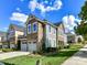 Beautiful townhouse showcasing a stone facade, attached garage, and green lawn on a sunny day with blue sky and white clouds at 9414 Glenburn Ln, Charlotte, NC 28278