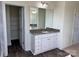 Bathroom featuring a granite countertop vanity, large mirror, and an open closet at 1022 Heath Helms Rd, Monroe, NC 28110