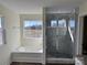 Bathroom featuring a tub, glass shower with stone floor, and a large window at 1022 Heath Helms Rd, Monroe, NC 28110