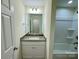 Bathroom with a granite countertop vanity, tub/shower combo, and white cabinets at 1022 Heath Helms Rd, Monroe, NC 28110