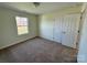 Bedroom with carpeted floors, closet, and a window at 1022 Heath Helms Rd, Monroe, NC 28110