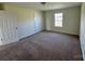 Bedroom with carpeted floors, closet, and a window at 1022 Heath Helms Rd, Monroe, NC 28110