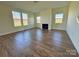 Bright living area with hardwood floors, electric fireplace, and multiple windows at 1022 Heath Helms Rd, Monroe, NC 28110
