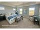 Serene primary bedroom with neutral tones, a tray ceiling, and plush carpeting at 1022 Heath Helms Rd, Monroe, NC 28110