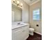 Well-lit bathroom with a white vanity, modern fixtures, and a toilet, perfect for everyday convenience at 10550 Worsley Ln, Charlotte, NC 28269