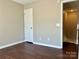 Minimalist bedroom with a doorway leading to an accessible staircase and an emphasis on open space at 10550 Worsley Ln, Charlotte, NC 28269
