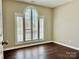 Bright bedroom with a large window offering natural light, complemented by neutral walls and flooring at 10550 Worsley Ln, Charlotte, NC 28269