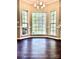 Dining room featuring hardwood floors, chair rail molding, and a bay window with a beautiful view at 10550 Worsley Ln, Charlotte, NC 28269
