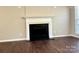 Living room with decorative fireplace and hardwood floors at 10550 Worsley Ln, Charlotte, NC 28269