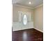 Elegant foyer with hardwood floors, decorative door with sidelights and trim detail at 10550 Worsley Ln, Charlotte, NC 28269