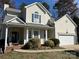 Charming two-story traditional home with a welcoming front porch and well-maintained landscaping at 10550 Worsley Ln, Charlotte, NC 28269
