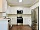Modern kitchen featuring white cabinets, stainless steel appliances, and a convenient over-the-range microwave at 10550 Worsley Ln, Charlotte, NC 28269