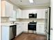 Modern kitchen featuring white cabinets, stainless steel appliances, and a convenient over-the-range microwave at 10550 Worsley Ln, Charlotte, NC 28269
