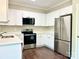 Modern kitchen featuring white cabinets, stainless steel appliances, and a convenient over-the-range microwave at 10550 Worsley Ln, Charlotte, NC 28269