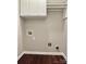Functional laundry room featuring overhead cabinets, washer and dryer hookups, and space-saving design at 10550 Worsley Ln, Charlotte, NC 28269