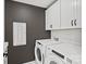 Convenient laundry room with modern washer and dryer, ample storage, and stylish cabinets at 1056 Kinship Dr # 113, Lancaster, SC 29720