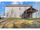 Back of the home with a covered patio and large yard with partial fencing at 10816 Pointer Ridge Dr, Charlotte, NC 28214