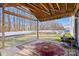 Covered patio and spacious backyard with white fencing and mature trees at 10816 Pointer Ridge Dr, Charlotte, NC 28214