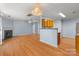 Spacious living room with fireplace, chandelier and open view into kitchen area at 10816 Pointer Ridge Dr, Charlotte, NC 28214