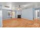 Bright living room features a fireplace, hardwood floors and a ceiling fan at 10816 Pointer Ridge Dr, Charlotte, NC 28214