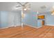 Open-concept living room features hardwood flooring, a chandelier, and a view into the kitchen at 10816 Pointer Ridge Dr, Charlotte, NC 28214