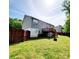 Spacious backyard featuring a wooden fence, lawn, and a wooden deck attached to the house at 115 Scotch Irish Ln, Troutman, NC 28166