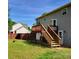 View of the house's backyard, including a new wooden deck and a well-maintained lawn at 115 Scotch Irish Ln, Troutman, NC 28166